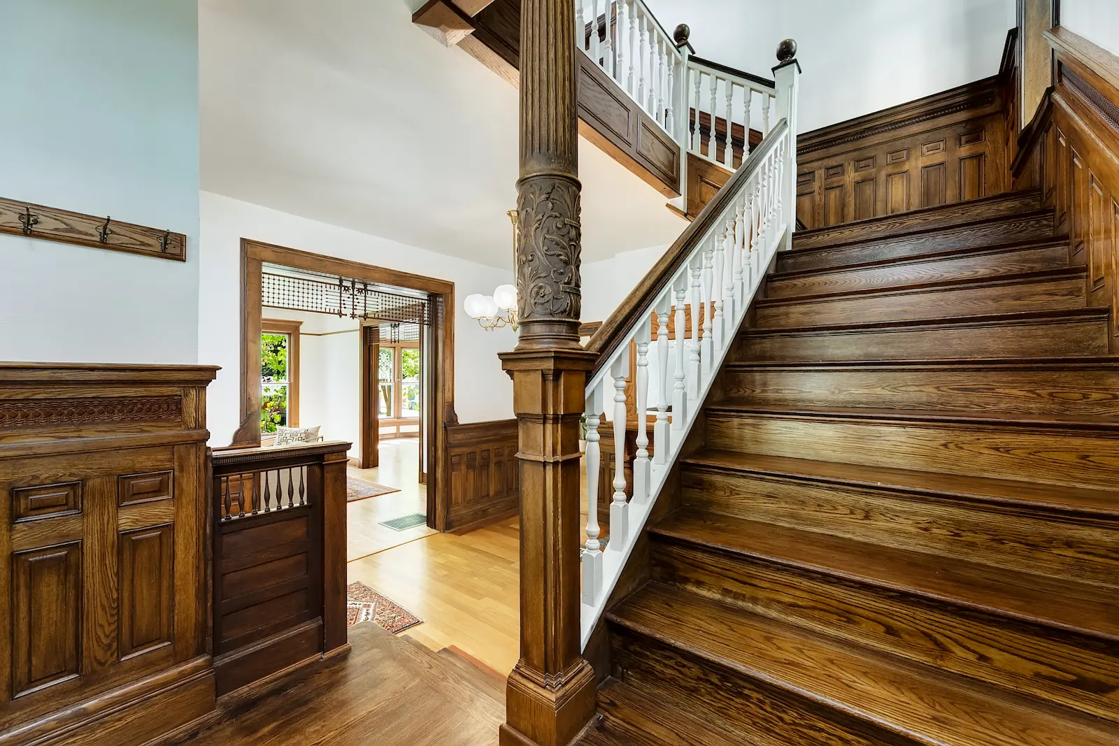 Historic Queen Anne Victorian in Boise's North End, in the entryway showing an exquisite hand-carved staircase.