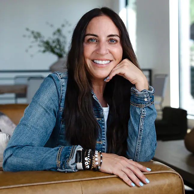 Becca Mendes on a luxury property couch