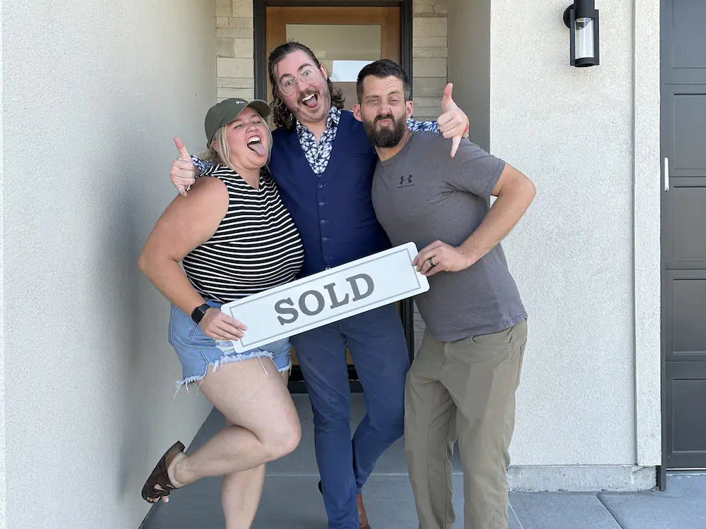 First-time Buyers celebrating in front of their luxury new construction home in Meridian.