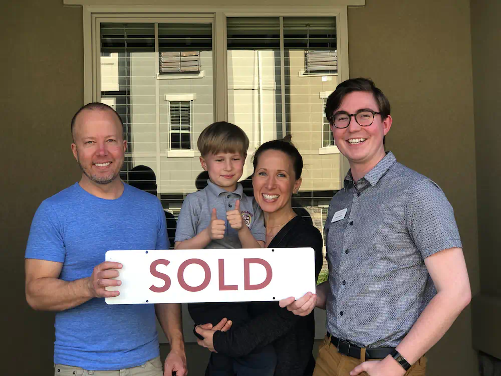 Oyler Family celebrating in front of their first home in Southeast Boise, a brand new townhome in Harris Ranch.